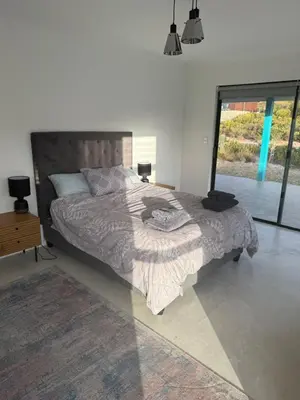 a bedroom with a large bed and a large window at Mountain View 2-Bedroom Home Near the Beach in Pringle Bay in Pringle Bay