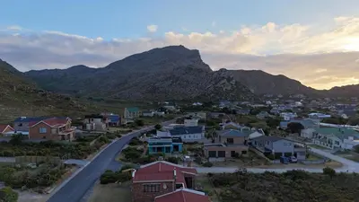 a small town with a mountain in the background at Mountain View 2-Bedroom Home Near the Beach in Pringle Bay in Pringle Bay