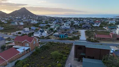 a small town with a mountain in the background at Mountain View 2-Bedroom Home Near the Beach in Pringle Bay in Pringle Bay