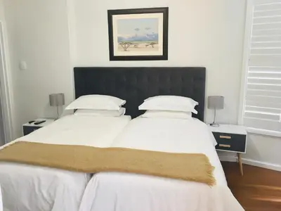two beds sitting next to each other in a bedroom at Just Joey Lodge in Stellenbosch