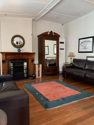 a living room with a couch and a fireplace at Just Joey Lodge in Stellenbosch