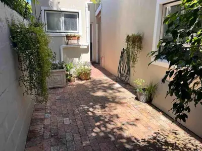 a brick walkway in front of a building at Secluded Silver Mile with solar back-up in Cape Town