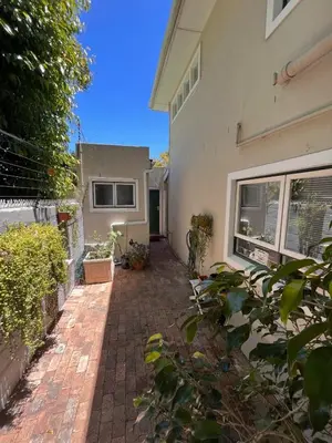 a brick walkway in front of a house at Secluded Silver Mile with solar back-up in Cape Town