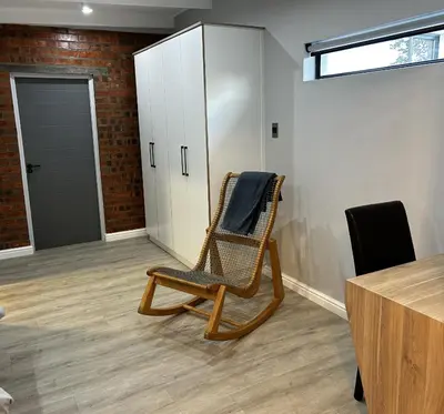 a wicker chair sitting in a room with a desk at Alicante self-catering 2 Bedroom apartment sleeps 4 in Worcester