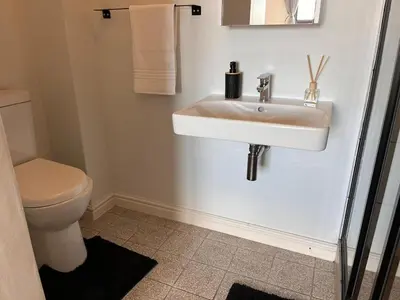 a bathroom with a sink and a toilet at EasyCapeTown - Bloubergstrand coastal apartment in Cape Town