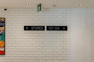 a wall with two street signs on a brick wall at Palmcrest Eden in Cape Town