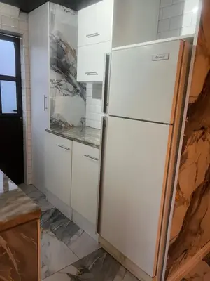 a kitchen being remodeled with a white refrigerator at Oryx guest house in Oakdale