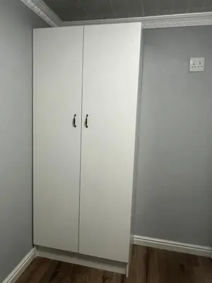 a white cabinet in the corner of a room at Oryx guest house in Oakdale