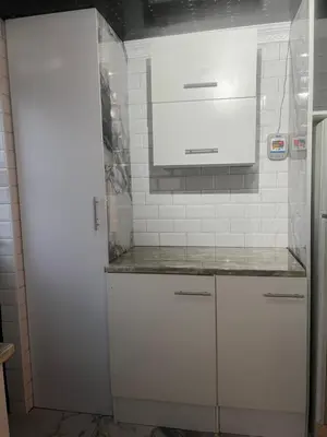 a kitchen with white cabinets and a microwave at Oryx guest house in Oakdale