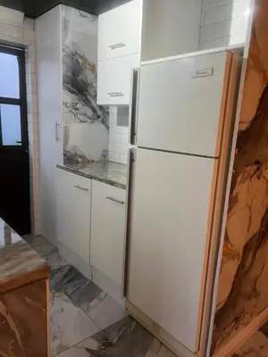 a kitchen with a white refrigerator in a room at Oryx guest house in Oakdale