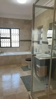 a bathroom with a tub and a toilet and a sink at Clements Apartment in Avondale