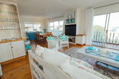 a living room with a couch and a table at Seabreeze in Hermanus