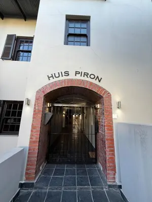 an entrance to a building with the huts firm sign on it at 1 at Huis Piron in Stellenbosch