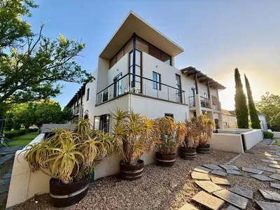 a house with potted plants in front of it at 1 at Huis Piron in Stellenbosch