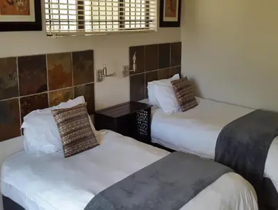 two beds in a hotel room with two beds sidx sidx sidx at Christal Villa A33 in Cape Town