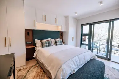 a bedroom with a large bed and a large window at 10 at The Alxndr - Stellenbosch Central in Stellenbosch
