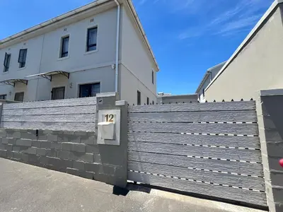 a wooden fence in front of a building at Valley Escape in Cape Town