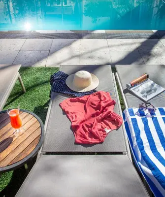 a picnic table with a hat and clothes on it at Oude Werf Hotel in Stellenbosch