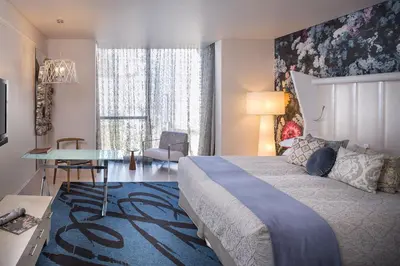 a hotel room with a bed and a desk and a room at Oude Werf Hotel in Stellenbosch