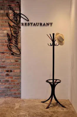 a hat on a stand in front of a wall at Oude Werf Hotel in Stellenbosch
