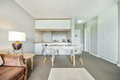 a living room with a table and a couch at Dolphin Beach Hotel Self Catering Apartments in Bloubergstrand