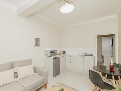 a living room with a couch and a table at Catalyst Guest House in Cape Town