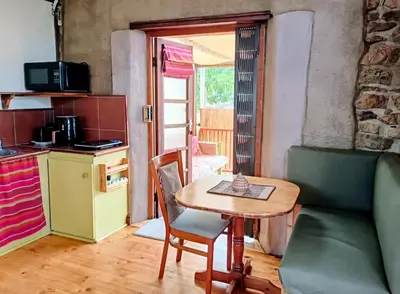 a kitchen with a table and a small table and chairs at Serene, cosy stay with a mountain view in Greyton