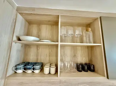 a cabinet filled with glasses and other glass items at 22 at The Den in Stellenbosch