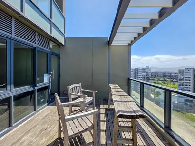 two wooden benches on a balcony of a building at Sea, Canal & Mountain View, Rooftop Jacuzzi & BBQ in Cape Town