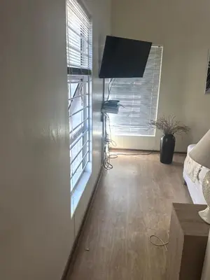 a living room with a window and a television at 22 on breezand in Cape Town