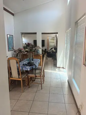 a dining room with a table and some chairs at 22 on breezand in Cape Town