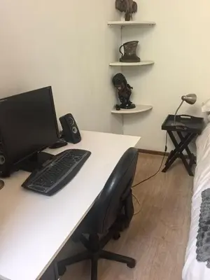 a desk with a computer and a keyboard and speakers at 22 on breezand in Cape Town