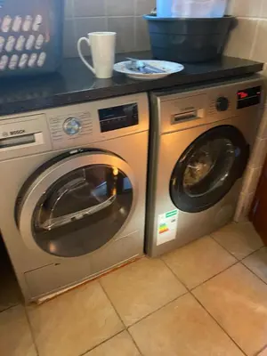 a washer and dryer in a kitchen with a counter at Pips Place Penthouse 501 in Strand