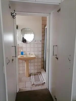 a bathroom with a sink and a mirror at Mimosa House Double Room in Brackenfell