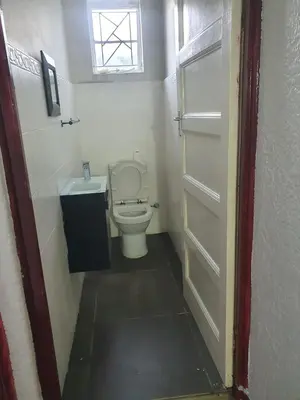 a small bathroom with a toilet and a window at Ludinz Self Catering Accommodation in Avondale