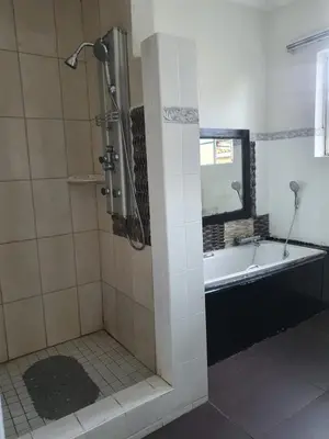 a bathroom with a bath tub and a shower at Ludinz Self Catering Accommodation in Avondale