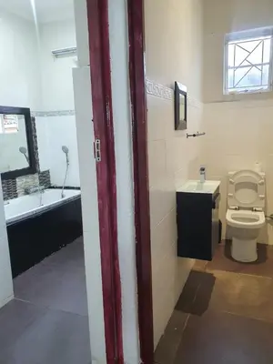 a bathroom with a toilet and a tub and a sink at Ludinz Self Catering Accommodation in Avondale