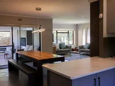 a kitchen with a table and a living room at House Nico in Hermanus
