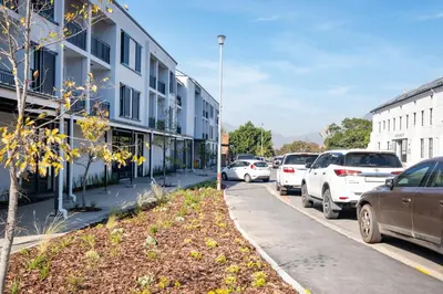 a street filled with parked cars next to buildings at 232 Paarl Studio With AC and Onsite Parking in Paarl