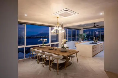 a kitchen and dining room with a table and chairs at Villa Solara, 6 bedroom Vacation Villa with sea view in Gordonʼs Bay