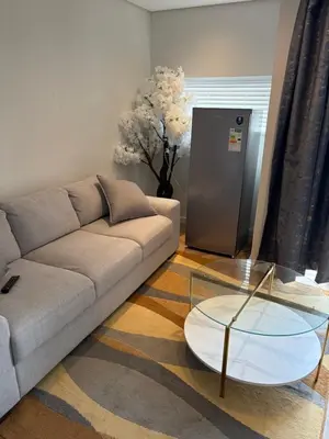 a living room with a couch and a glass table at Urban Ridge in Cape Town