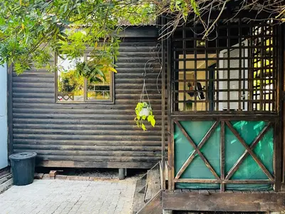 a wooden house with a door and a window at Cross Road Cabin in Cape Town