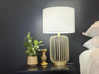 a lamp on a table with a plant on it at Sunset View in Durbanville