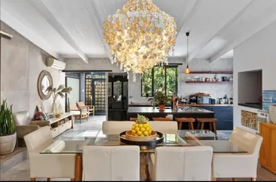 a dining room and kitchen with a chandelier at Beach House Living in Gordonʼs Bay