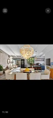 a living room with a chandelier and a dining room at Beach House Living in Gordonʼs Bay