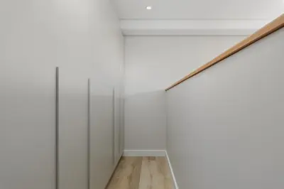 a hallway with white walls and a wooden floor at Burmeister Modern 2-Bedroom w/ Views Milnerton in Cape Town