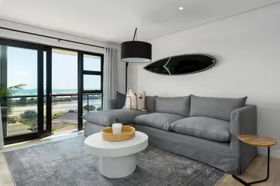 a living room with a couch and a table at Burmeister Modern 2-Bedroom w/ Views Milnerton in Cape Town