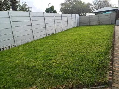 a fence in a yard with green grass at OakwayGuestSuit2 Private 1 Bed Kitchen Bath Aircon in Kuilsrivier