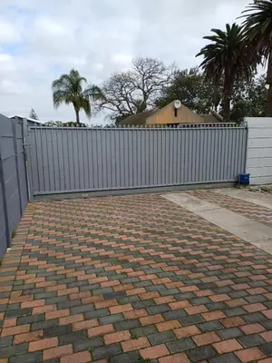 a white fence in front of a house at OakwayGuestSuit2 Private 1 Bed Kitchen Bath Aircon in Kuilsrivier