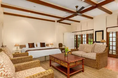a bedroom with a bed and a couch and a table at Gable Manor by Neighbourgood in Franschhoek